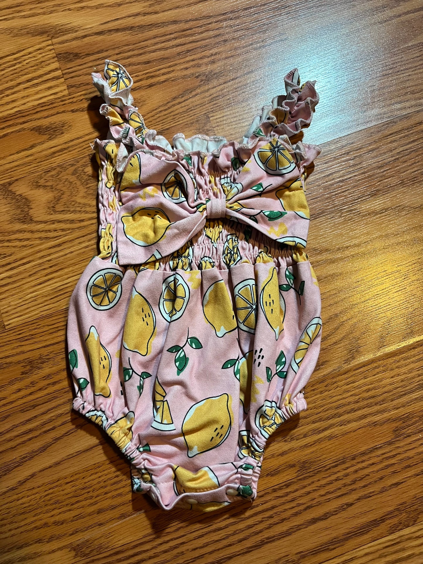 Baby girls pink lemon size 74 bubble romper (online says 6/9 months it is stretchy but looks closer to 6 months)